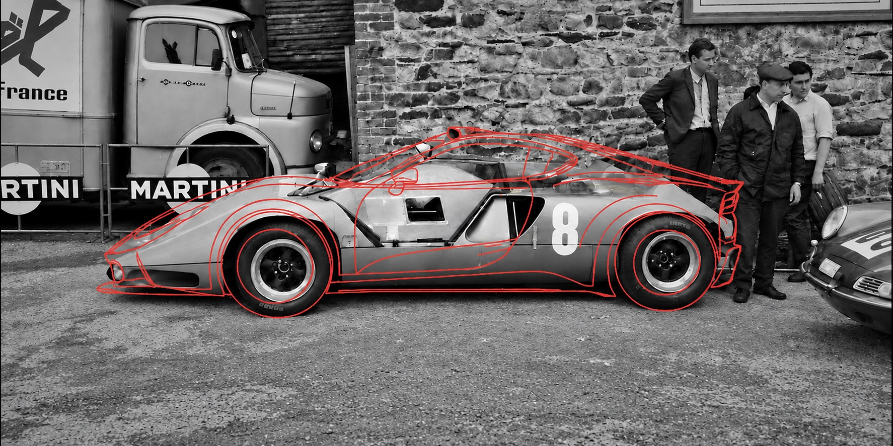 AI-enhanced photograph of the 1968 Marcos Mantis XP in the paddock at Spa, with a red outline drawing of the 2026 Marcos Manticore superimposed on the car — the marque's past and future in one frame