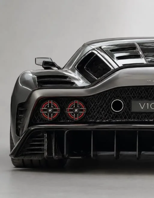 The Marcos Manticore photographed rear-on in a studio, showing its quad exhausts, carbon rear diffuser and aerodynamics